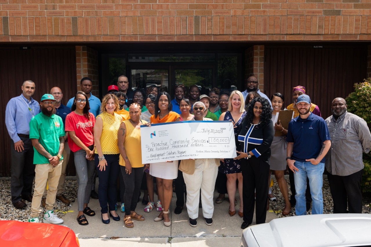 Proactive Community Solutions poses with a big check